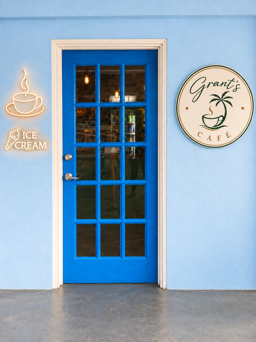 Blue door and round sign for Grant's Café at Point Bay Resort